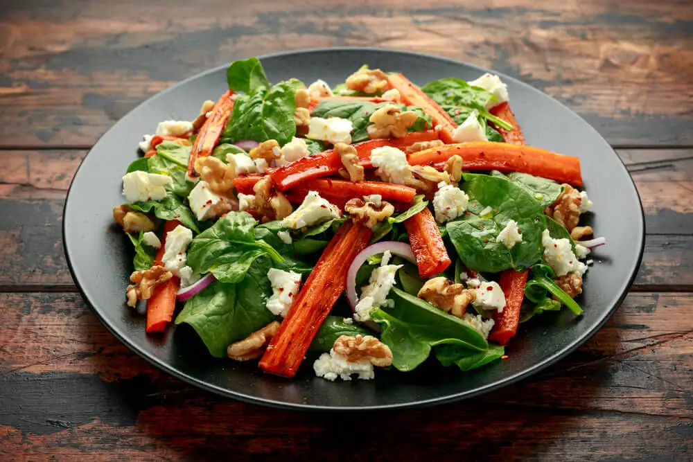 Roasted Carrot And Feta Salad presented in a beautiful black matte plate 