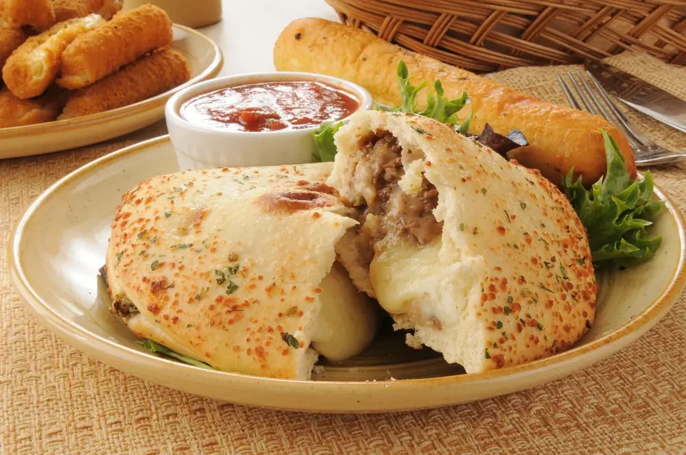 Steak and Cheese Calzone served in a white plate