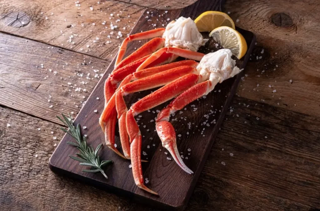 snow crab legs on a wooden board